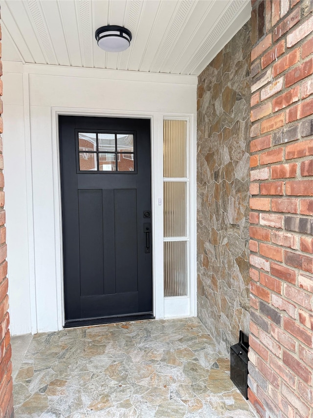 entrance to property with stone siding