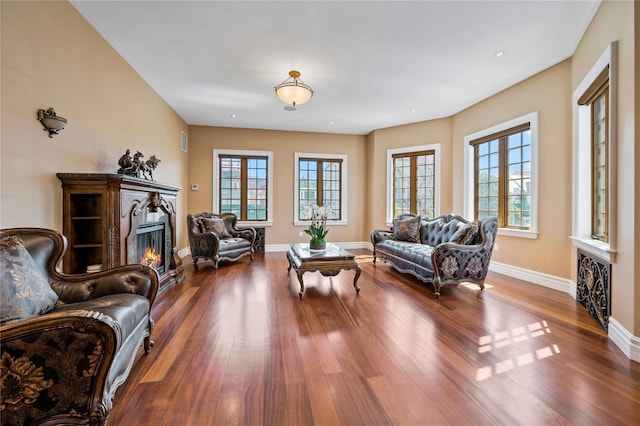 117 Malba Dr, Malba, NY 11357 - living area with recessed lighting, a glass covered fireplace, wood finished floors, and baseboards