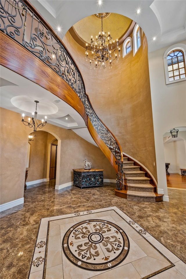 117 Malba Dr, Malba, NY 11357 - entryway with marble finish floor, arched walkways, a towering ceiling, baseboards, and a notable chandelier