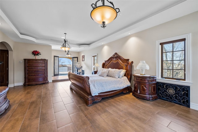 117 Malba Dr, Malba, NY 11357 - bedroom featuring recessed lighting, arched walkways, wood finished floors, and a raised ceiling