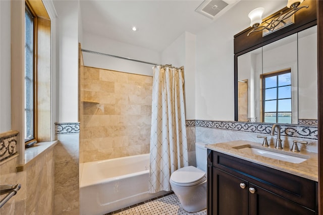 117 Malba Dr, Malba, NY 11357 - full bath with shower / bath combo, toilet, tile walls, wainscoting, and vanity