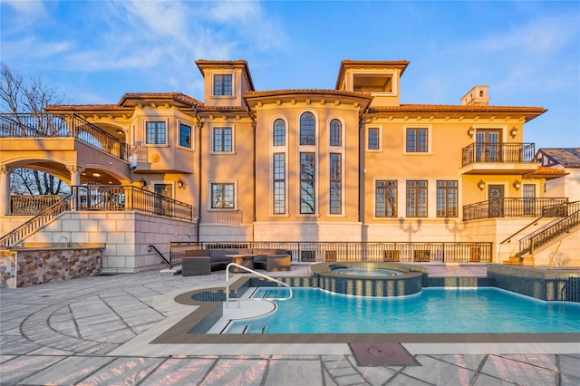 117 Malba Dr, Malba, NY 11357 - back of house with a balcony, outdoor lounge area, a patio, stairs, and a pool with connected hot tub