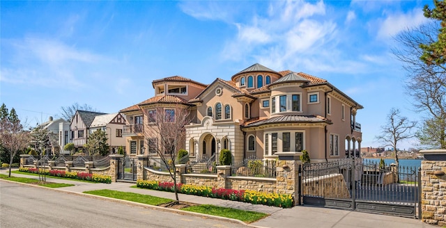 117 Malba Dr, Malba, NY 11357 - victorian house featuring a gate, stucco siding, stone siding, and a fenced front yard