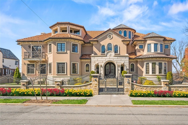 117 Malba Dr, Malba, NY 11357 - mediterranean / spanish-style house featuring stucco siding, a tile roof, a fenced front yard, and a gate