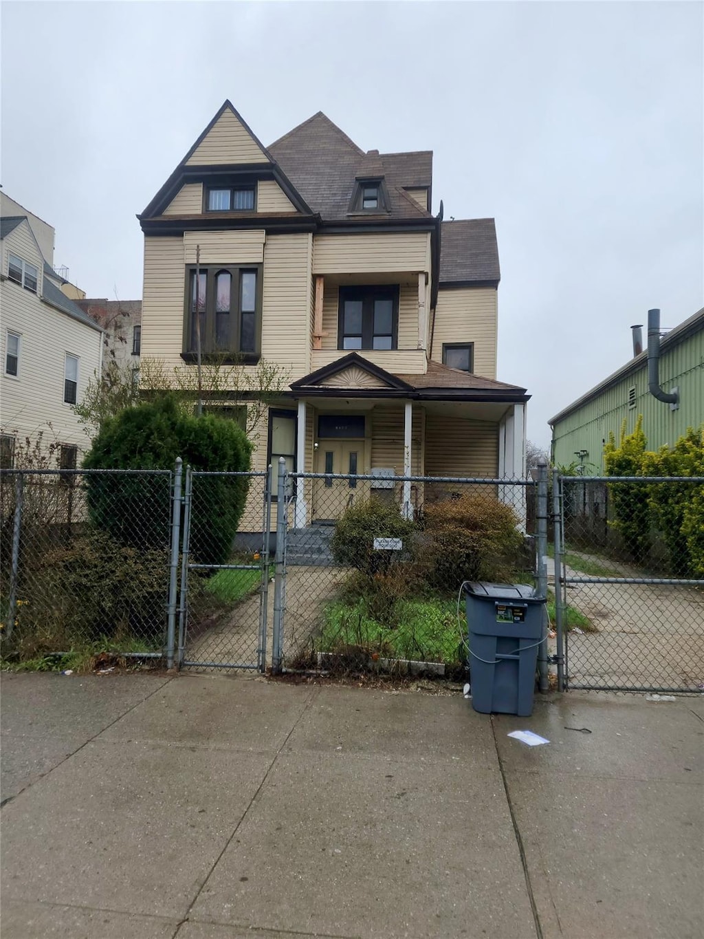 victorian house with a gate and a fenced front yard