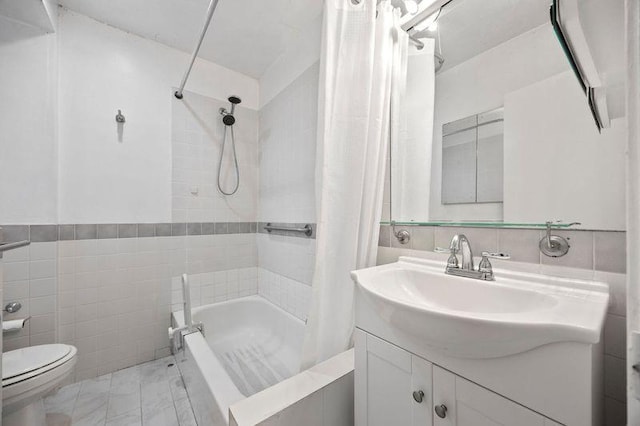 bathroom with vanity, shower / bath combo, toilet, and tile walls