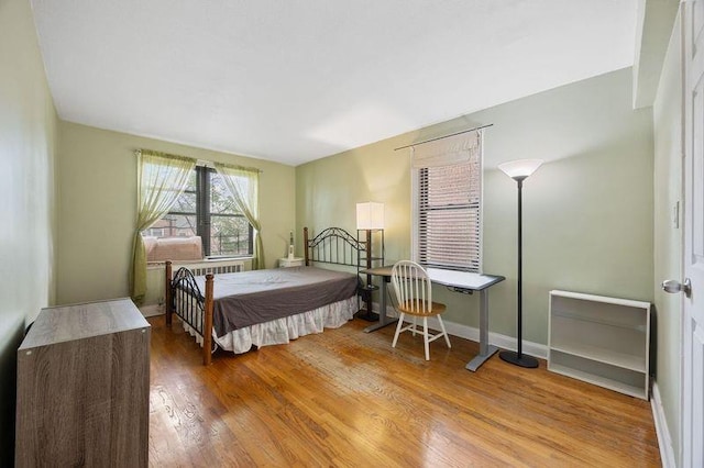 bedroom featuring baseboards and wood finished floors