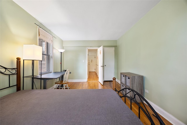 bedroom featuring baseboards and wood finished floors