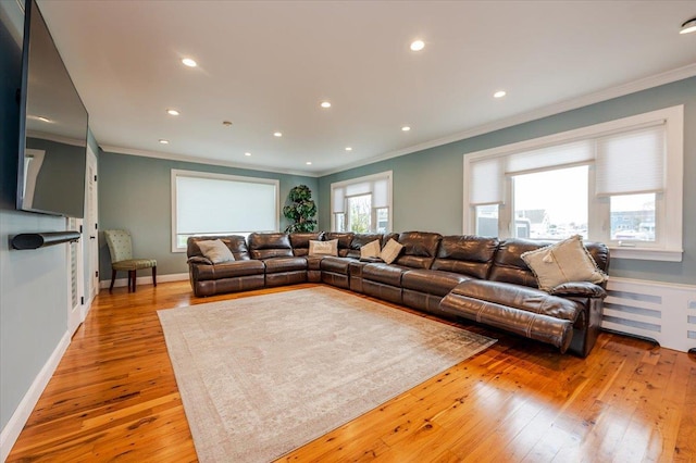 living area featuring light wood finished floors, recessed lighting, and ornamental molding