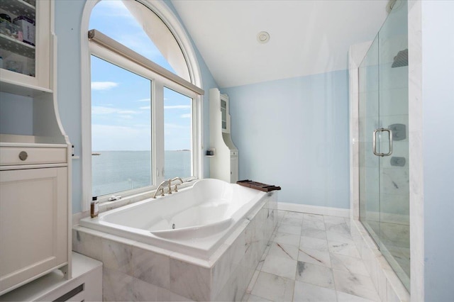 bathroom featuring a water view, vaulted ceiling, marble finish floor, a shower stall, and a garden tub