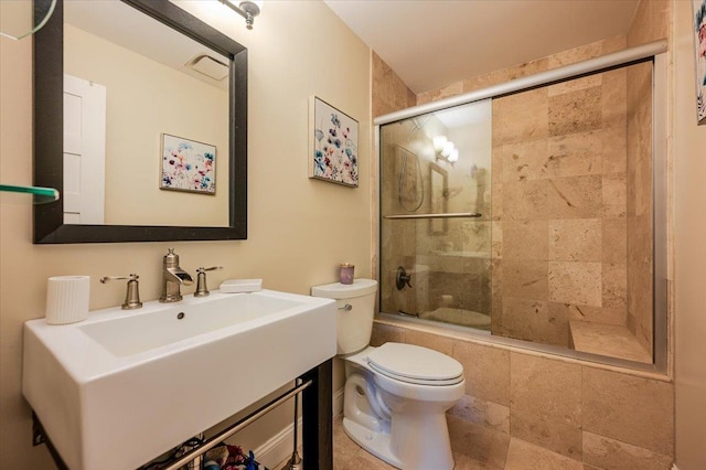 full bath with toilet, vanity, and a tile shower