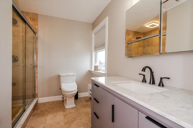 bathroom with a shower stall, visible vents, toilet, vanity, and baseboards