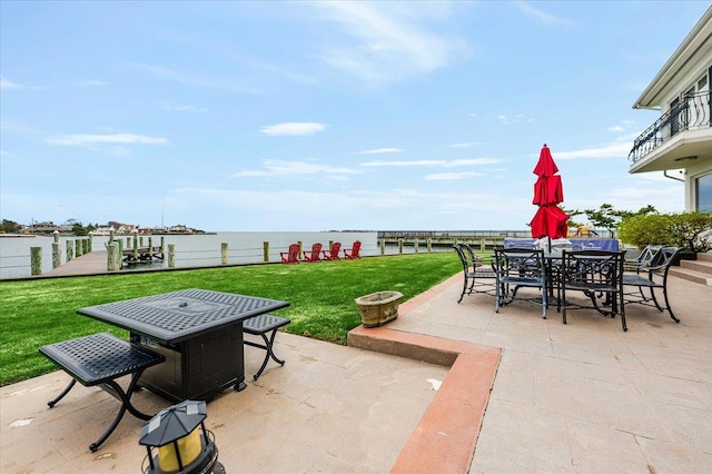 view of patio / terrace with a water view and outdoor dining space