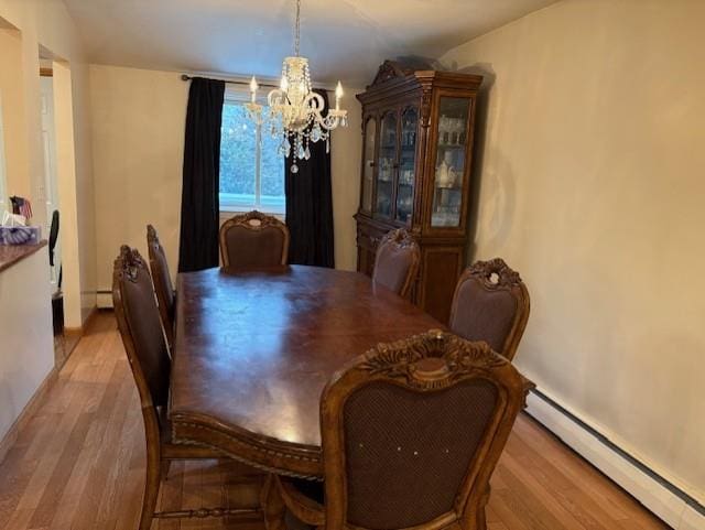 19 Yeoman Dr, East Northport, NY 11731 - dining space featuring a notable chandelier, wood finished floors, and a baseboard heating unit