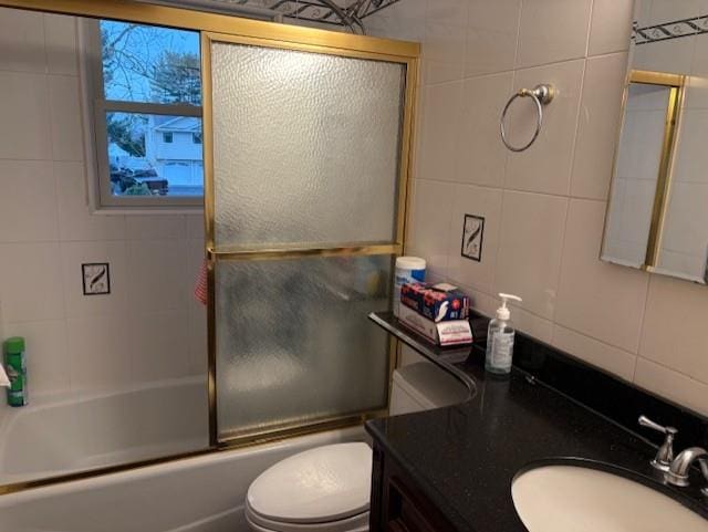 19 Yeoman Dr, East Northport, NY 11731 - full bathroom with vanity, shower / bath combination with glass door, tile walls, toilet, and backsplash