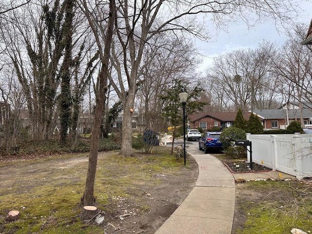 view of street with a residential view, street lighting, and sidewalks