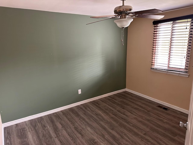 unfurnished room with visible vents, wood finished floors, baseboards, and ceiling fan