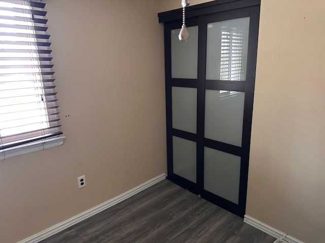 interior space with dark wood finished floors and baseboards