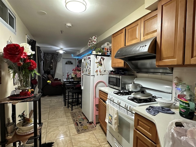 108-14 35th Ave, Corona, NY 11368 - kitchen with light countertops, white appliances, light tile patterned floors, under cabinet range hood, and brown cabinets