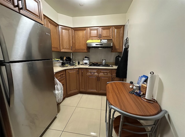 108-14 35th Ave, Corona, NY 11368 - kitchen featuring light countertops, freestanding refrigerator, gas cooktop, under cabinet range hood, and light tile patterned floors