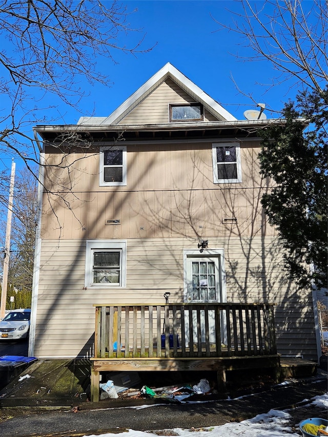 back of house with a deck