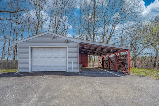 garage featuring driveway and a detached garage