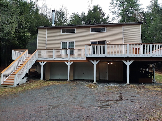 44 Lester Ln, Bethel, NY 12786 - rear view of property with driveway, a wooden deck, a garage, and stairway