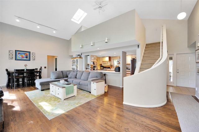 18 Warner Ct, Baiting Hollow, NY 11933 - living area with track lighting, wood finished floors, high vaulted ceiling, and stairs