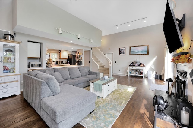 18 Warner Ct, Baiting Hollow, NY 11933 - living area featuring a towering ceiling, baseboards, track lighting, stairs, and wood finished floors