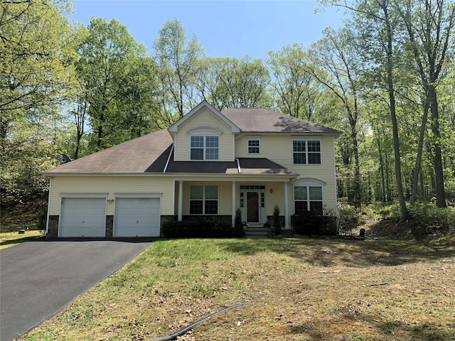 504 St. Ives Court, Lehman Township, PA 18324 - view of front facade with driveway, a garage, a front lawn, and covered porch