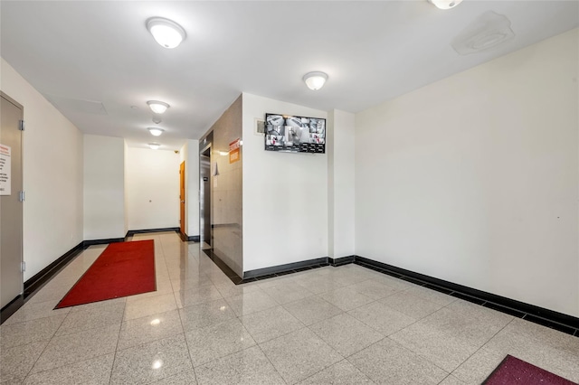 interior space with baseboards and granite finish floor