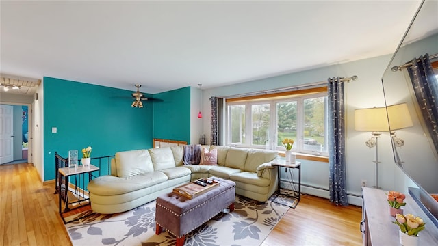 living room with wood finished floors and baseboard heating