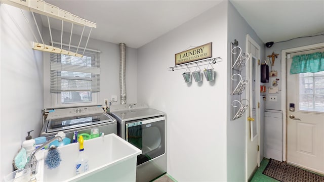 laundry area featuring laundry area, a sink, and washer and clothes dryer