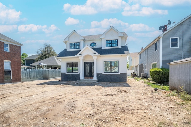 49 E Cherry St, Hicksville, NY 11801 - view of front of home with fence, roof with shingles, central AC unit, and stucco siding