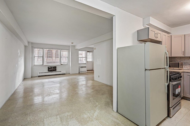 89-15 Parsons Blvd Unit 3J, Jamaica, NY 11432 - kitchen featuring tasteful backsplash, radiator heating unit, light floors, a baseboard radiator, and appliances with stainless steel finishes