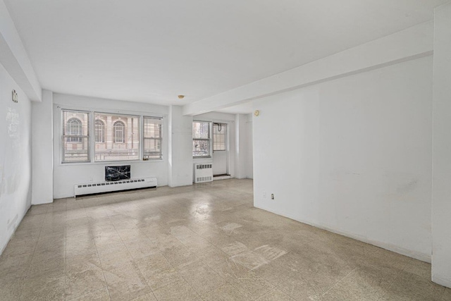 89-15 Parsons Blvd Unit 3J, Jamaica, NY 11432 - unfurnished living room with tile patterned floors, radiator heating unit, and a baseboard heating unit
