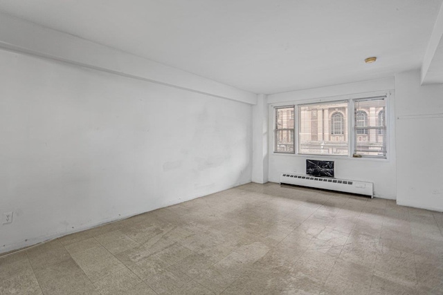 89-15 Parsons Blvd Unit 3J, Jamaica, NY 11432 - unfurnished living room with tile patterned floors and a baseboard heating unit