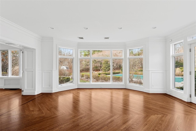 unfurnished sunroom with visible vents and radiator