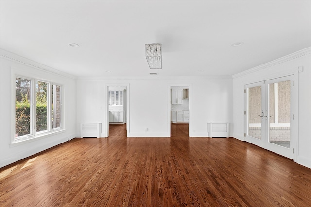 spare room featuring ornamental molding, visible vents, wood finished floors, french doors, and baseboards