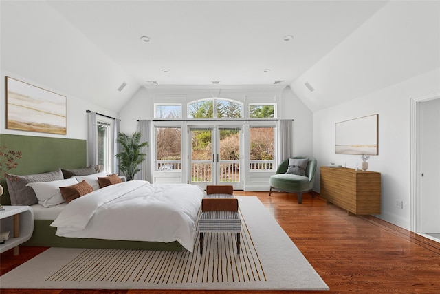 bedroom with wood finished floors, visible vents, and vaulted ceiling