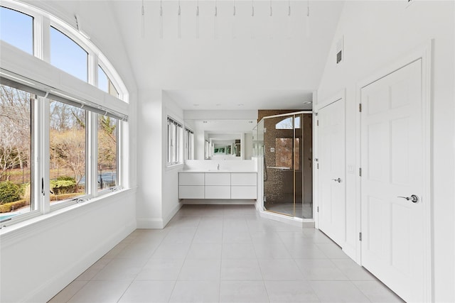 bathroom featuring visible vents, baseboards, vanity, tile patterned flooring, and a stall shower