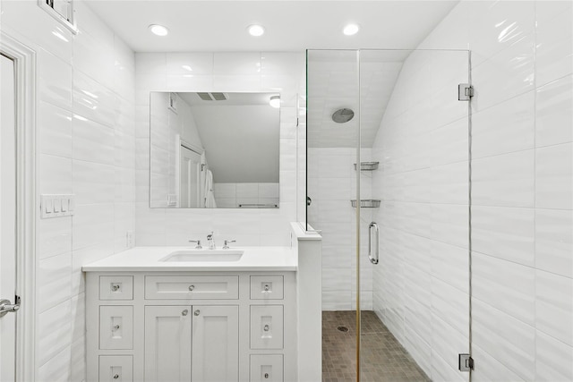 full bath featuring tasteful backsplash, visible vents, tile walls, vanity, and a stall shower