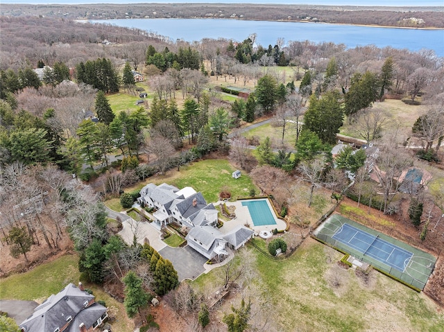 birds eye view of property featuring a wooded view and a water view