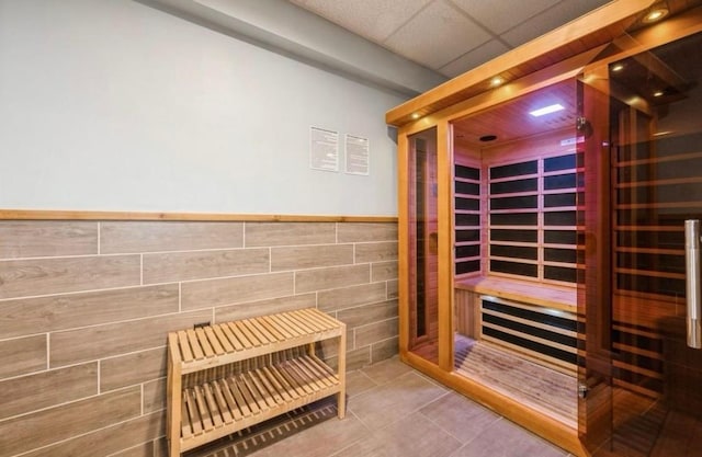 view of sauna featuring tile patterned flooring and wainscoting