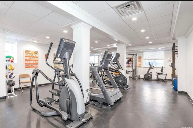 workout area featuring a paneled ceiling, baseboards, recessed lighting, visible vents, and decorative columns