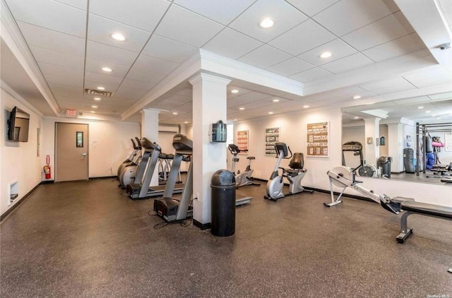 gym with crown molding, a tray ceiling, recessed lighting, and an AC wall unit