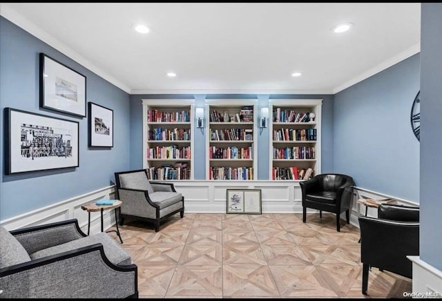 sitting room with recessed lighting, built in features, and ornamental molding