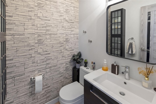 bathroom featuring toilet and vanity