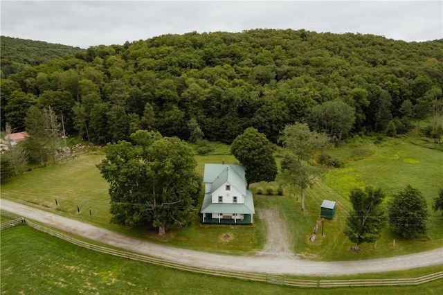 birds eye view of property featuring a rural view and a view of trees