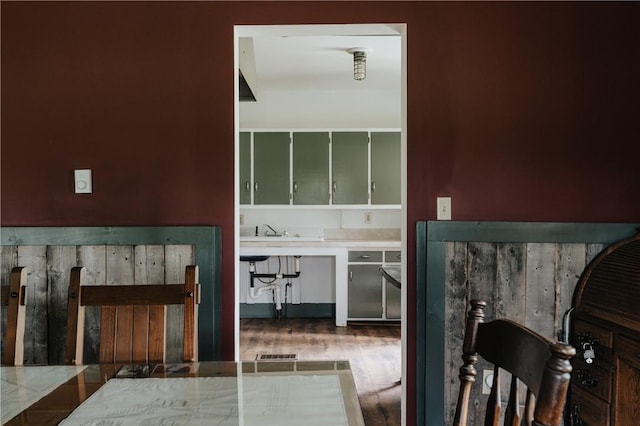 interior space with a sink and wood finished floors